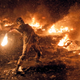 In this Wednesday, Jan. 22, 2014 file photo a protester throws a Molotov cocktail during clashes with police in central Kiev, Ukraine.